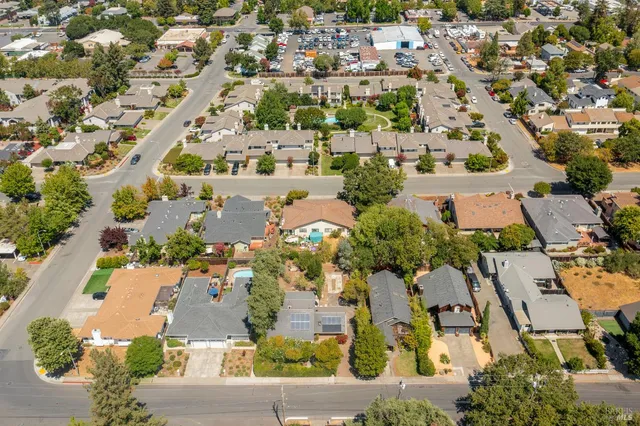 an aerial view of residential houses with outdoor space