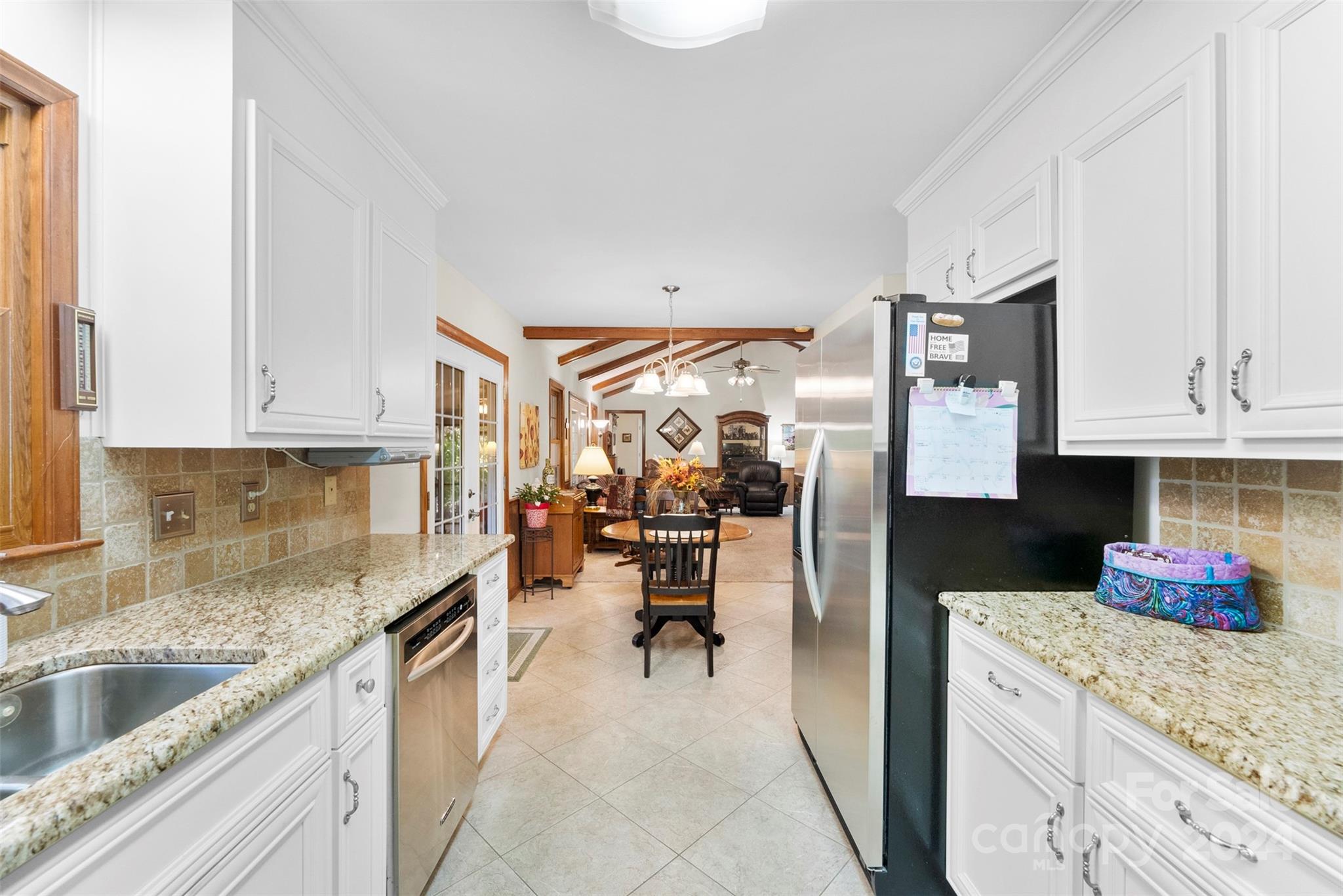 4356 Old Forge Drive Gastonia, NC 28056 - Photo 13 of 39 a kitchen with granite countertop kitchen island stainless steel appliances a stove refrigerator sink and cabinets