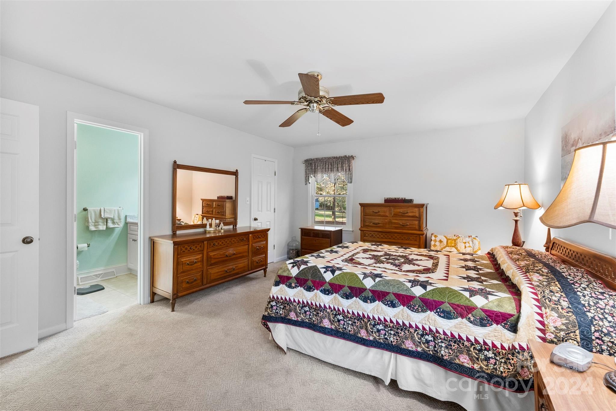 4356 Old Forge Drive Gastonia, NC 28056 - Photo 33 of 39 a bedroom with a bed and a chandelier