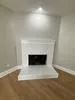 a view of empty room with a fireplace