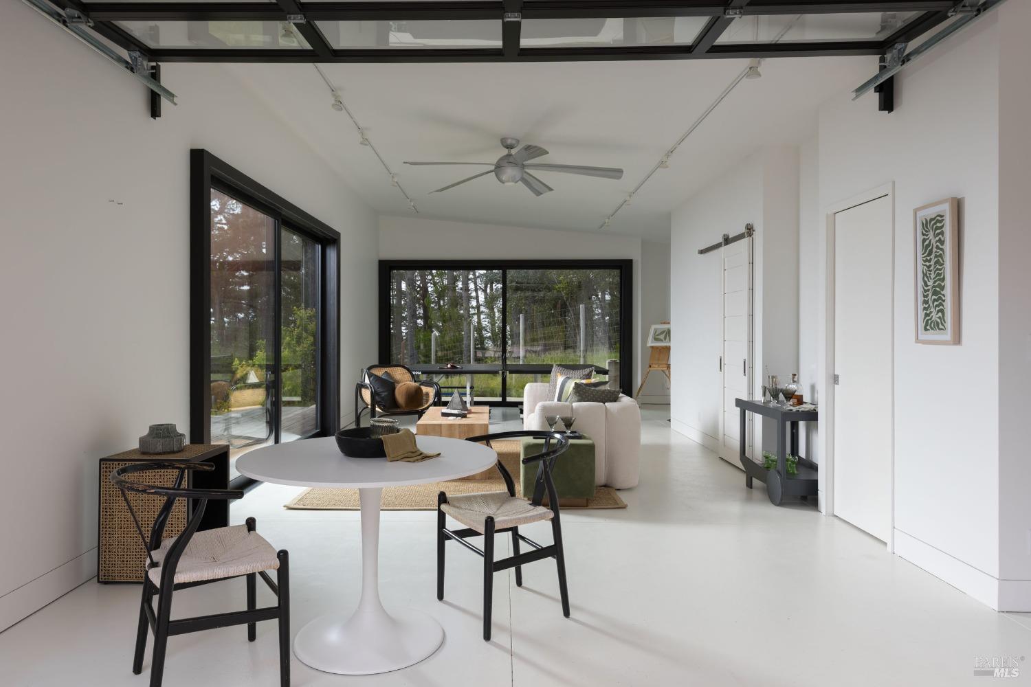18800 Fitzpatrick Lane Occidental, CA 95465 - Photo 26 of 35 a living room with fireplace furniture and a large window