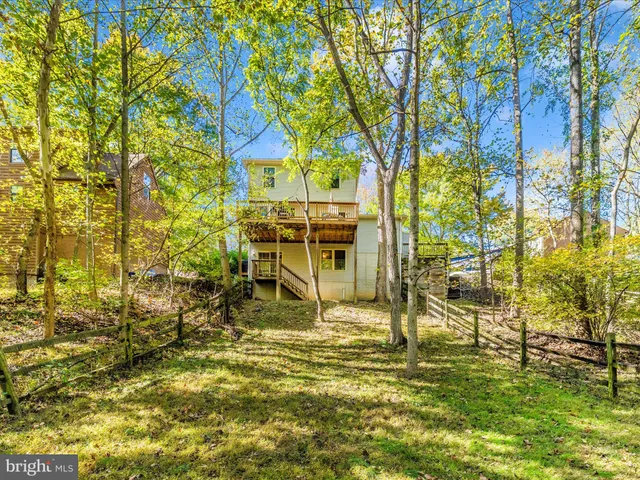 a kitchen with stainless steel appliances granite countertop a stove a sink and a granite counter tops with white cabinets
