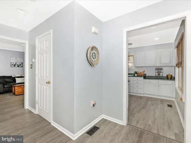 a living room with furniture a flat screen tv and a large window