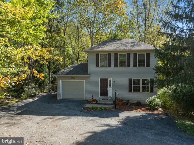 front view of a house with a tree