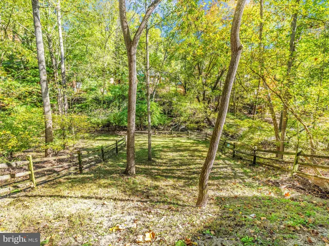 an aerial view of residential houses with outdoor space and lake view