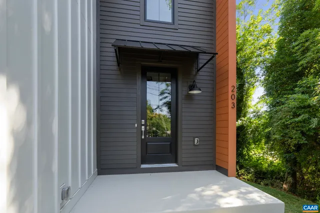 a large kitchen with stainless steel appliances kitchen island a large counter top a sink a stove and a refrigerator