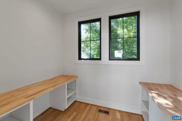 a view of room with window and wooden floor