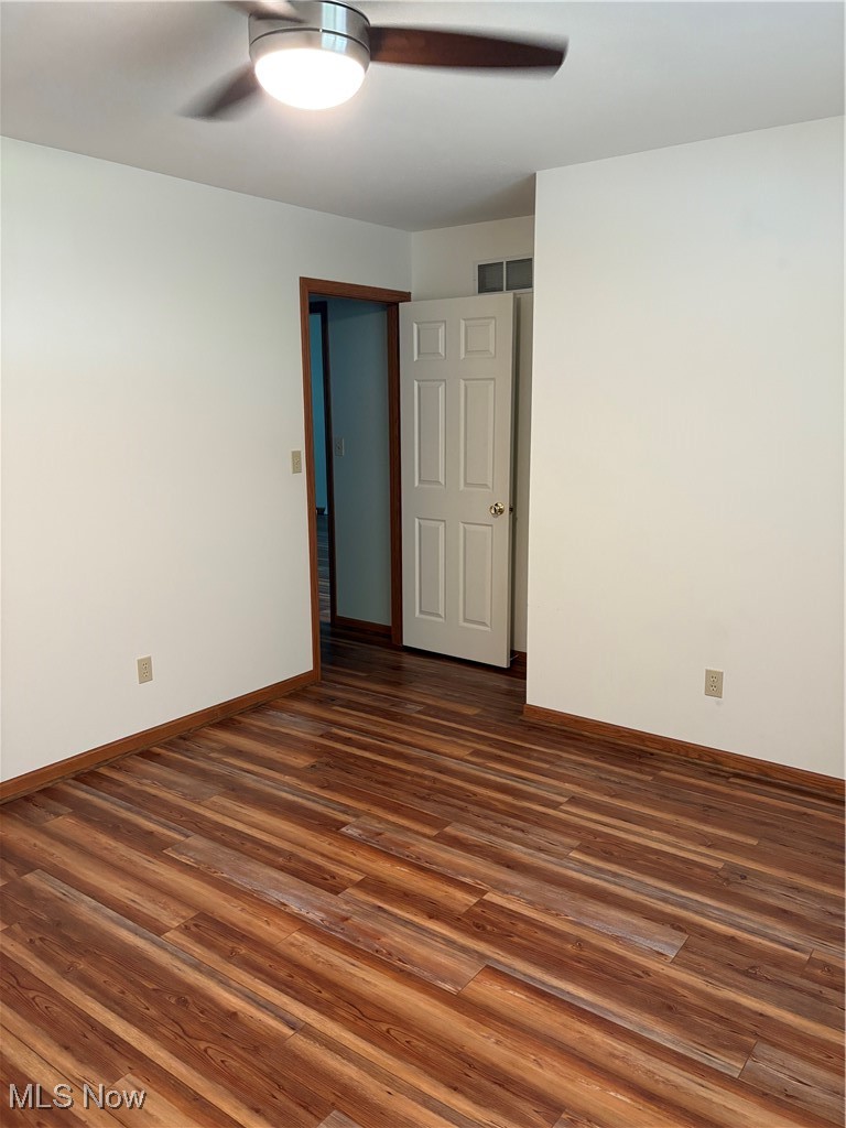 6695 Clingan Road, Unit 24 Youngstown, OH 44514 - Photo 18 of 26 Spare room featuring dark wood-style floors and a ceiling fan