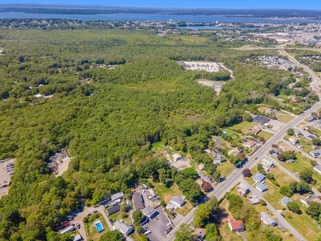 an aerial view of a houses with a yard