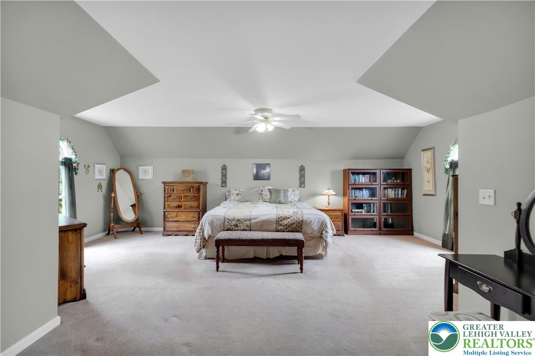 3830 McIntosh Drive Orefield, PA 18069 - Photo 15 of 36 a bedroom with furniture and a lamp