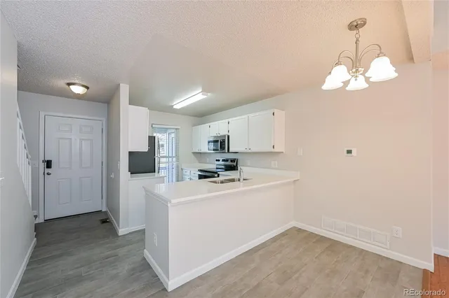 a view of a kitchen sink and a microwave