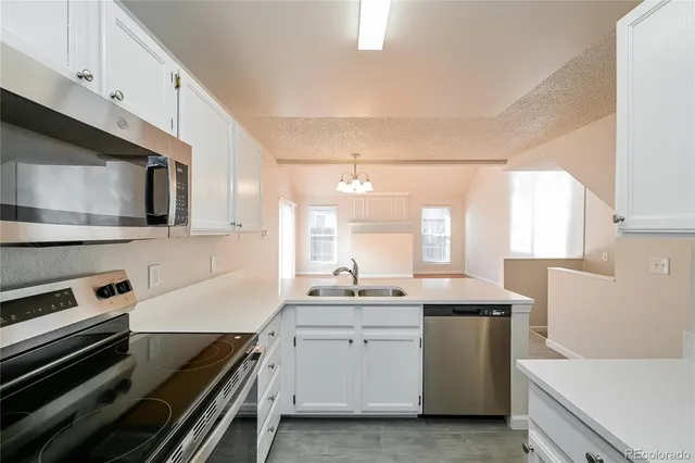 a kitchen with a sink stove and microwave