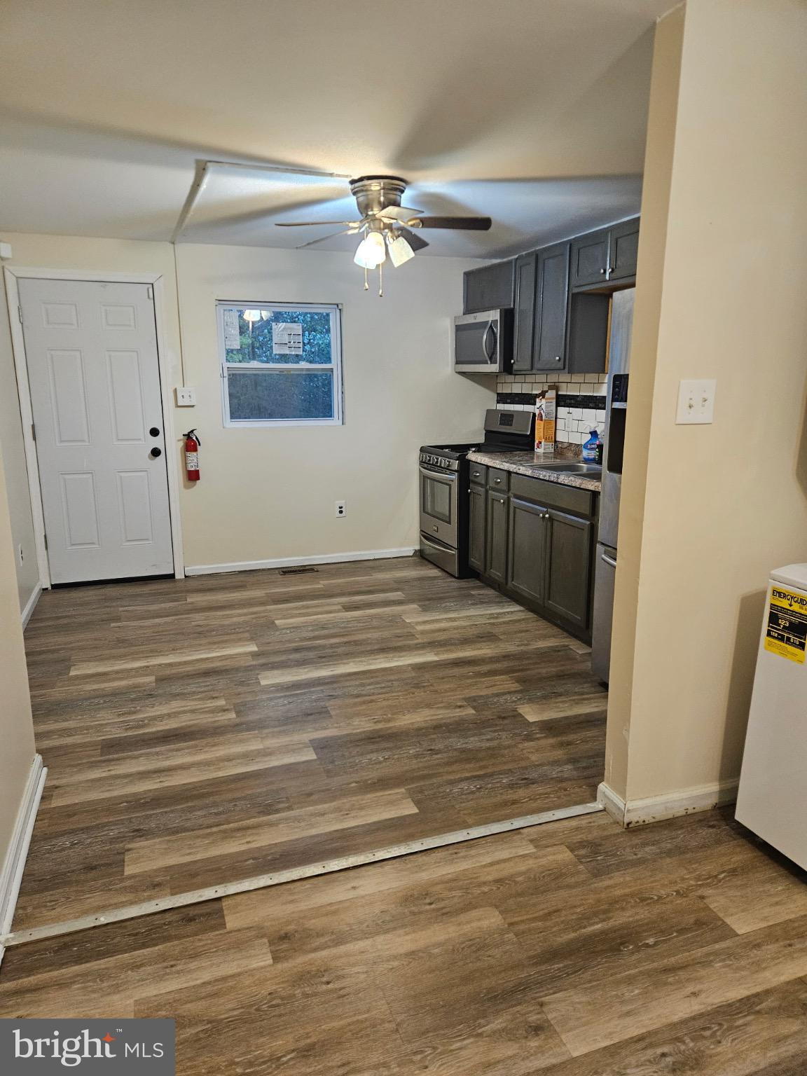 229 Sinnickson Street Salem, NJ 08079 - Photo 6 of 12 a view of kitchen and empty room with wooden floor