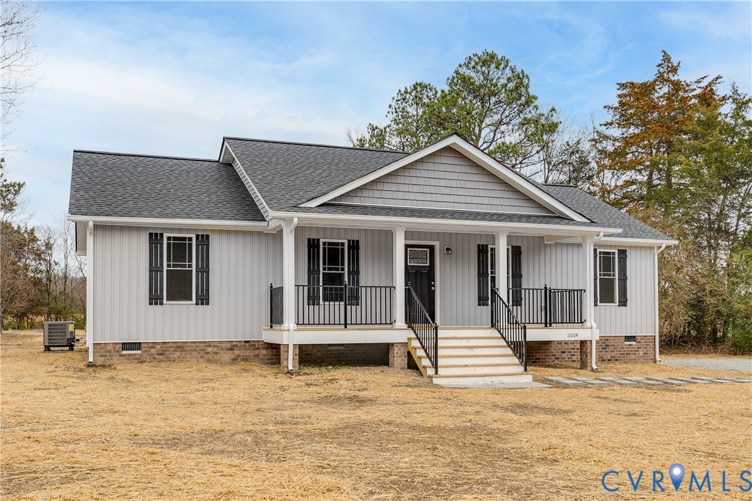 2545 Wickham Road Bumpass, VA 23024 - Photo 2 of 23 a front view of a house with a wooden bench