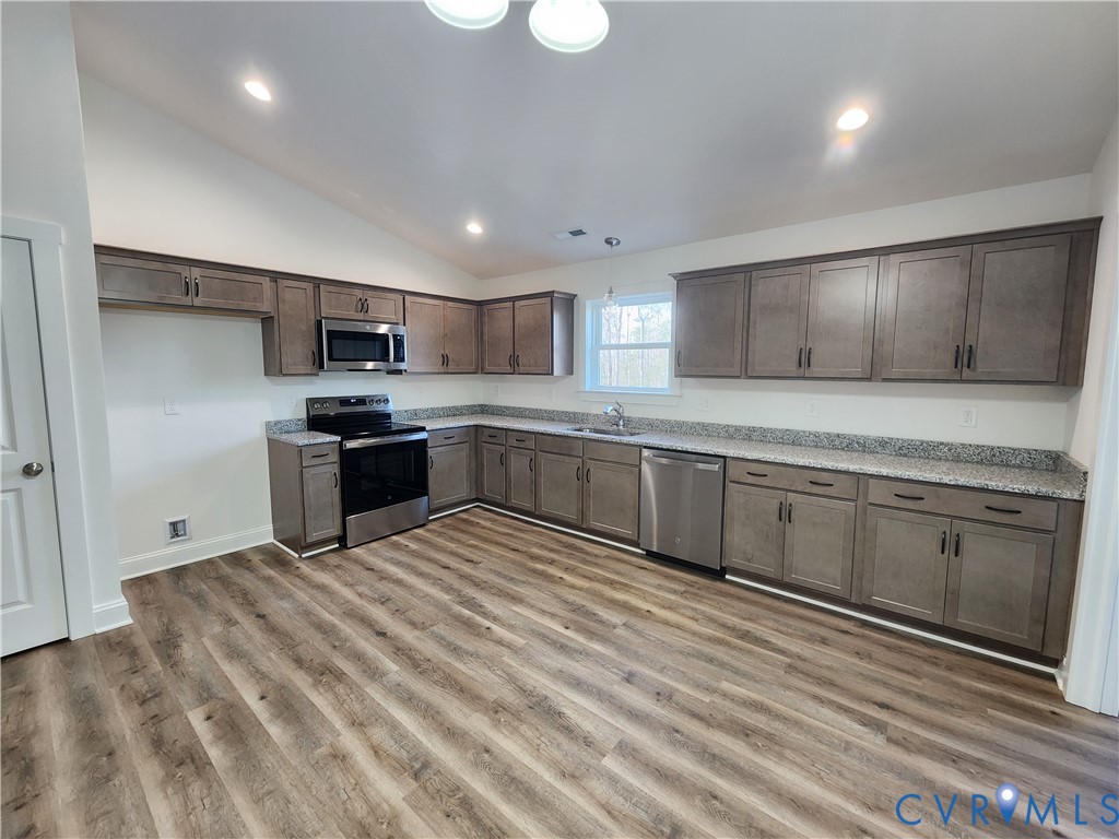 2545 Wickham Road Bumpass, VA 23024 - Photo 5 of 23 a large kitchen with cabinets stainless steel appliances and a counter space