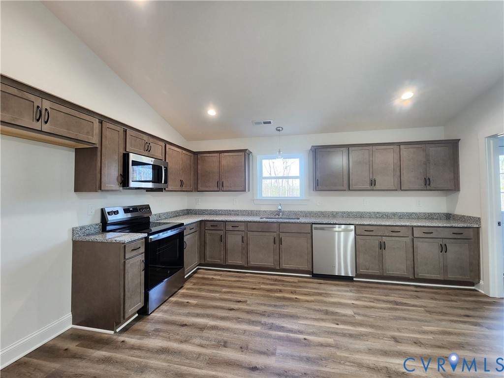2545 Wickham Road Bumpass, VA 23024 - Photo 7 of 23 a kitchen with stainless steel appliances granite countertop a stove top oven a sink dishwasher and a refrigerator