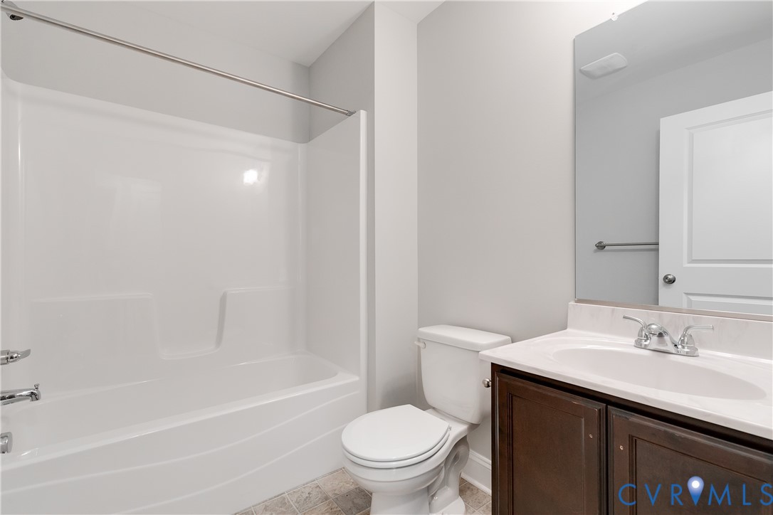 2545 Wickham Road Bumpass, VA 23024 - Photo 10 of 23 a bathroom with a sink a toilet and a bathtub