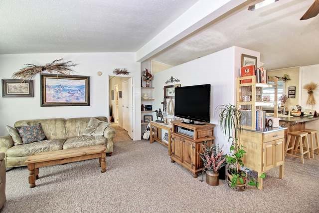 2135 M Road Grand Junction, CO 81505 - Photo 27 of 42 a living room with furniture and a flat screen tv