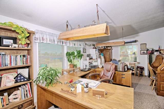 2135 M Road Grand Junction, CO 81505 - Photo 31 of 42 a living room with furniture and a book shelf