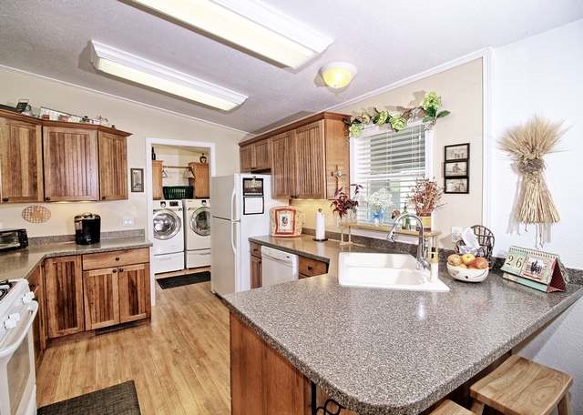 2135 M Road Grand Junction, CO 81505 - Photo 32 of 42 a kitchen with stainless steel appliances granite countertop a sink a stove and refrigerator