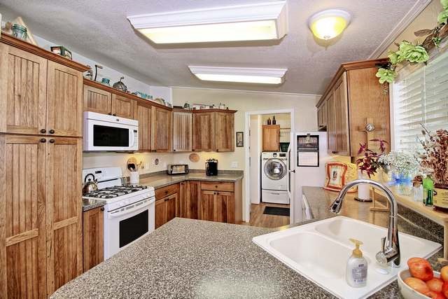 2135 M Road Grand Junction, CO 81505 - Photo 33 of 42 a kitchen with stainless steel appliances granite countertop a sink stove and refrigerator