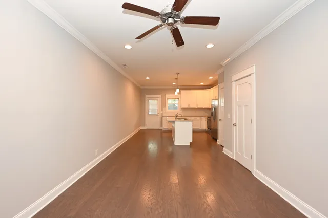 a view of empty room with wooden floor