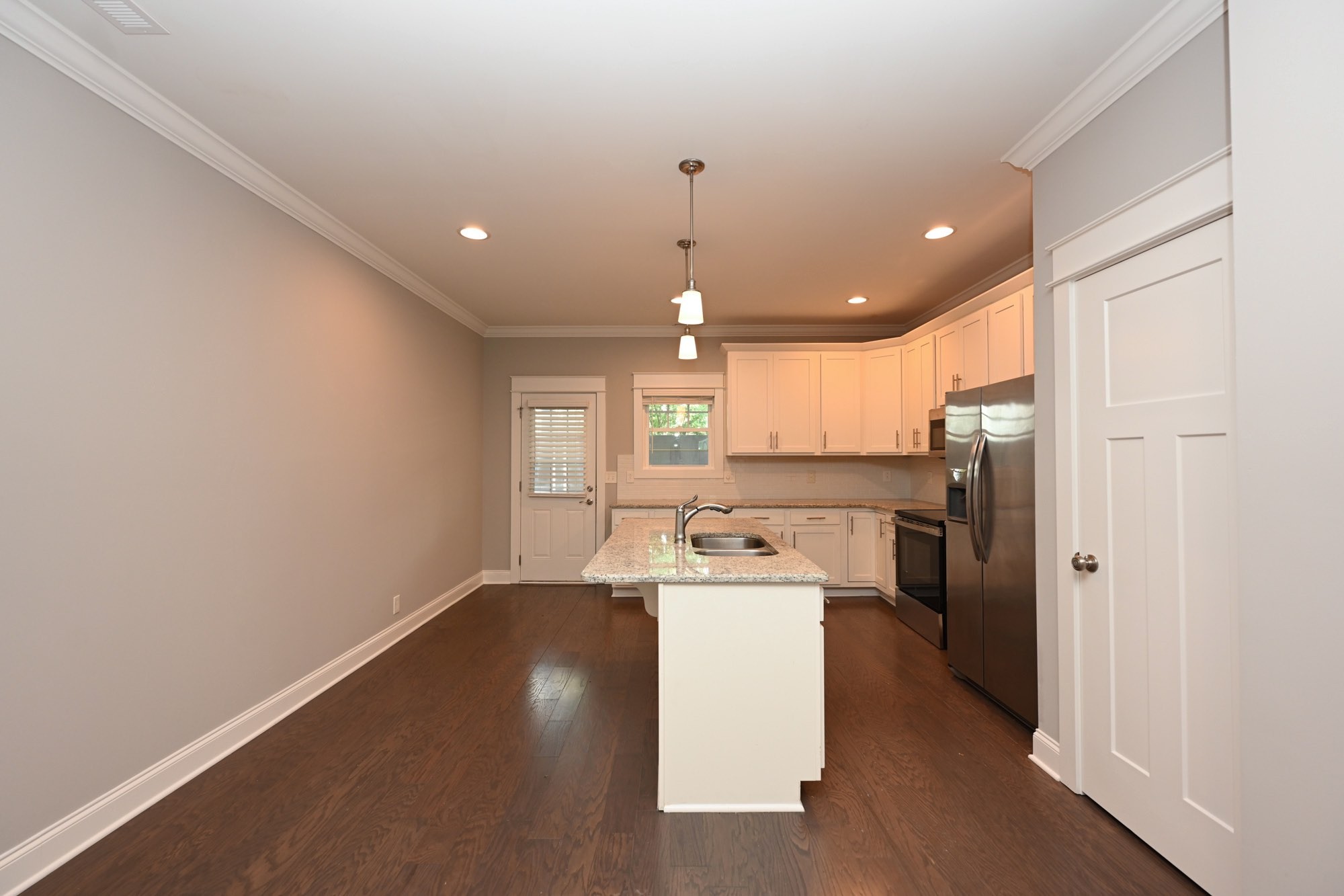1019 North Maple Street, Unit 2D Murfreesboro, TN 37130 - Photo 19 of 56 a view of a kitchen with a sink wooden floor and a window