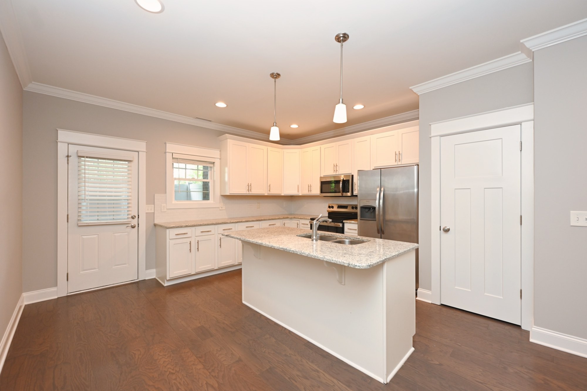 1019 North Maple Street, Unit 2D Murfreesboro, TN 37130 - Photo 20 of 56 a kitchen with kitchen island a sink appliances and cabinets