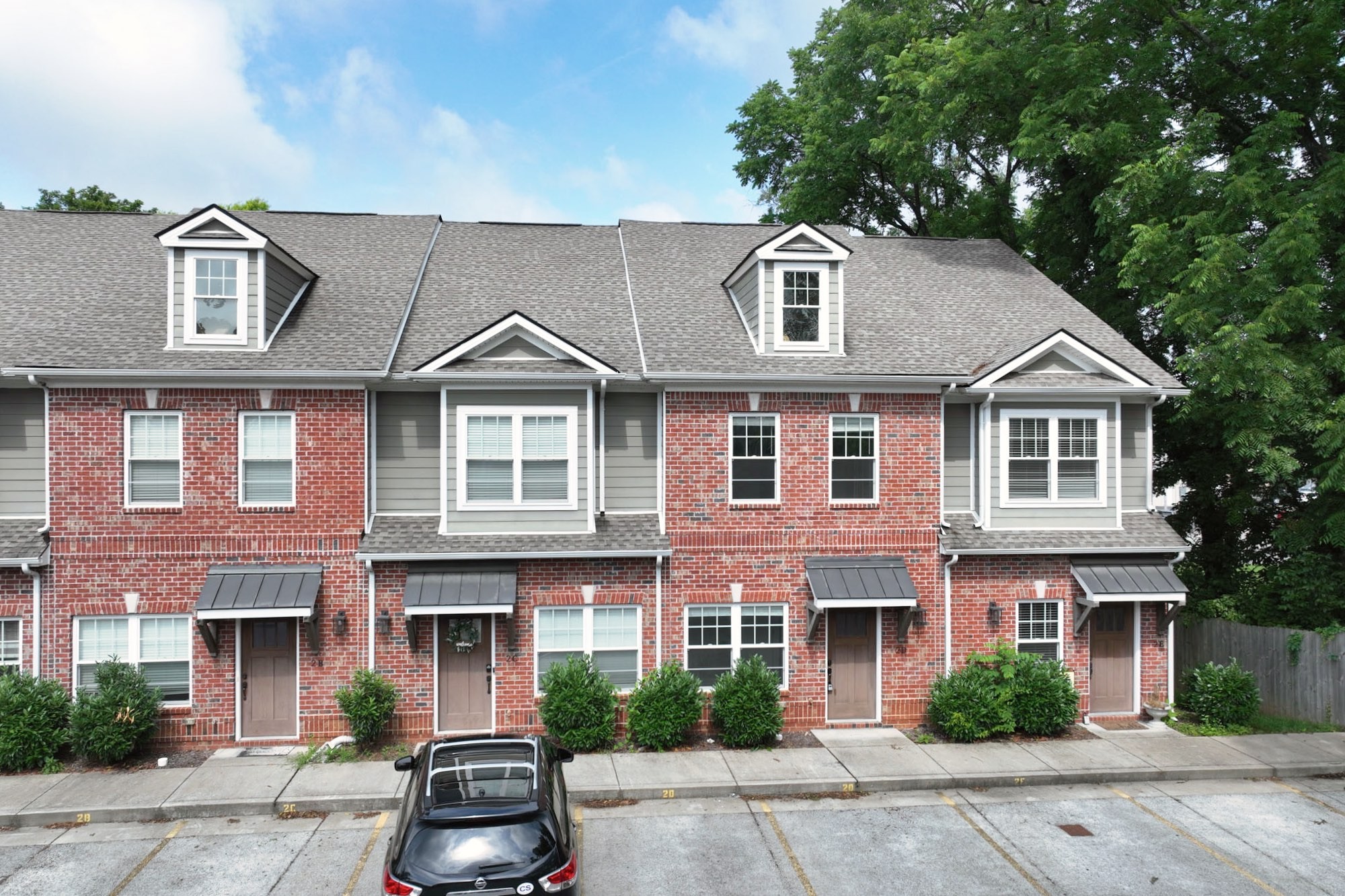 1019 North Maple Street, Unit 2D Murfreesboro, TN 37130 - Photo 2 of 56 a front view of a house with a yard and garage
