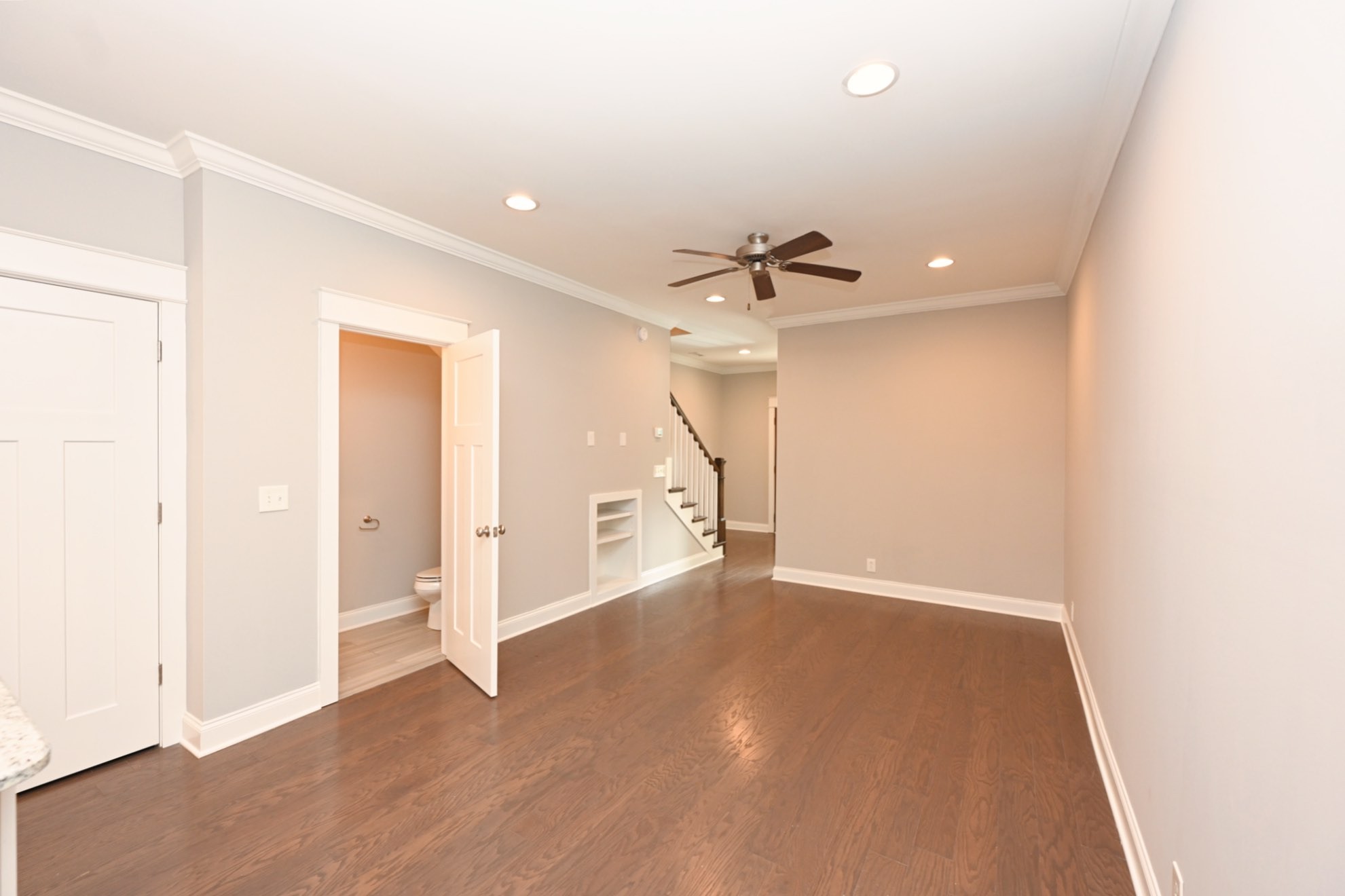 1019 North Maple Street, Unit 2D Murfreesboro, TN 37130 - Photo 26 of 56 a view of an empty room with wooden floor and a ceiling fan