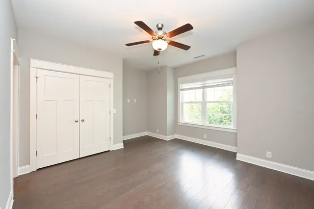 a view of a livingroom with a ceiling fan and window