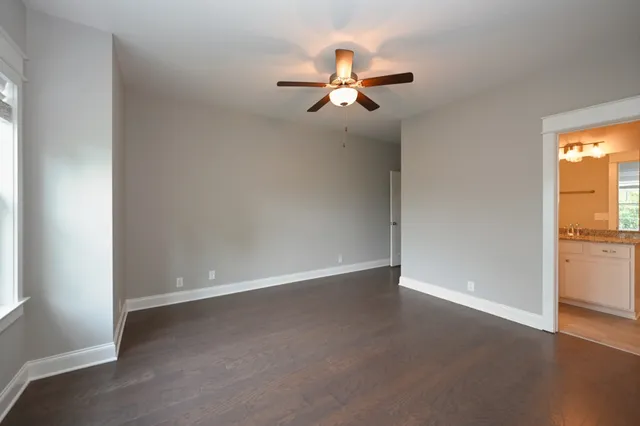 a bathroom with a granite countertop sink a toilet and bathtub