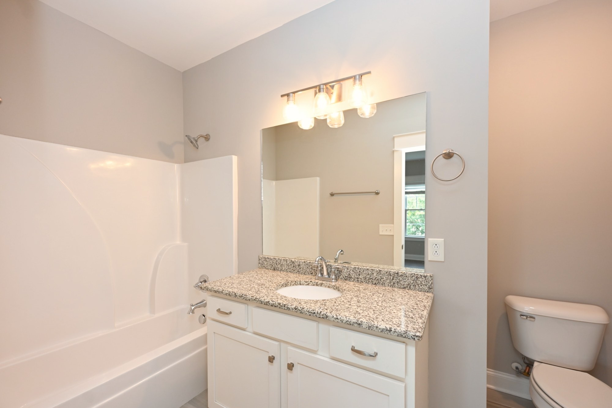 1019 North Maple Street, Unit 2D Murfreesboro, TN 37130 - Photo 32 of 56 a bathroom with a granite countertop sink a toilet and bathtub