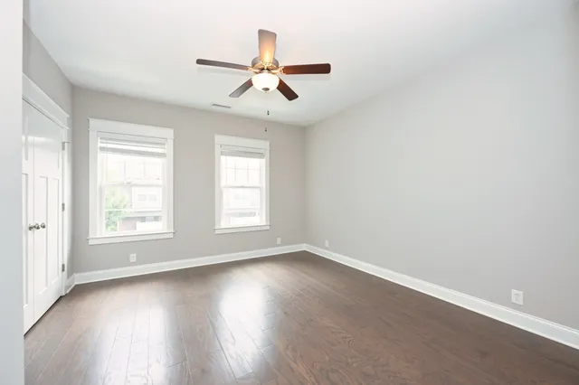 a view of a livingroom with a ceiling fan and window