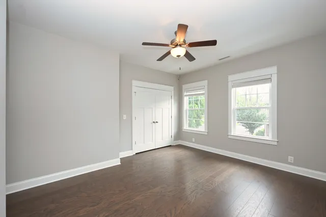 a bathroom with a granite countertop sink a mirror and a shower
