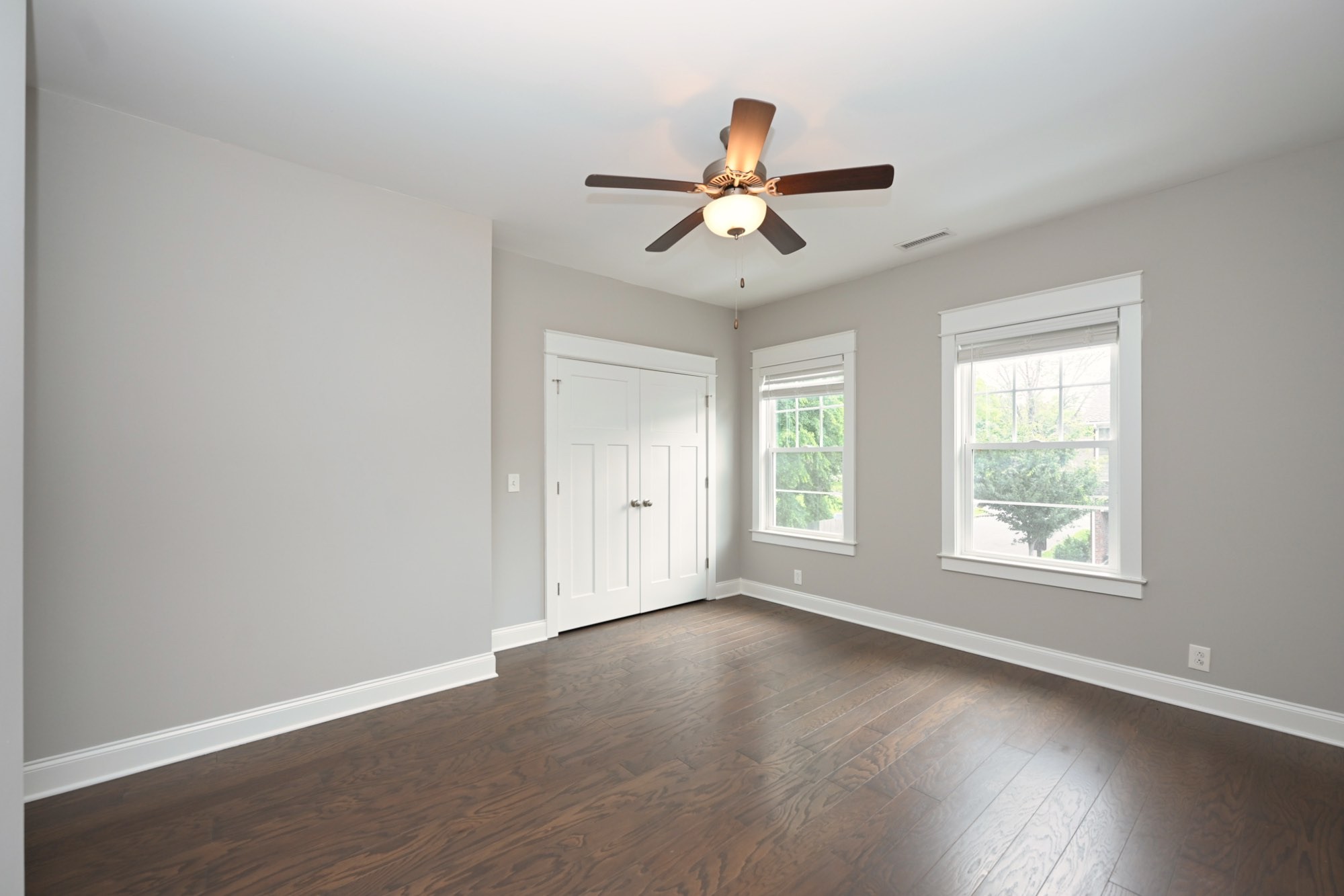 1019 North Maple Street, Unit 2D Murfreesboro, TN 37130 - Photo 34 of 56 an empty room with wooden floor fan and windows