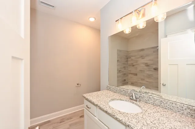 a view of a hallway with wooden floor and closet