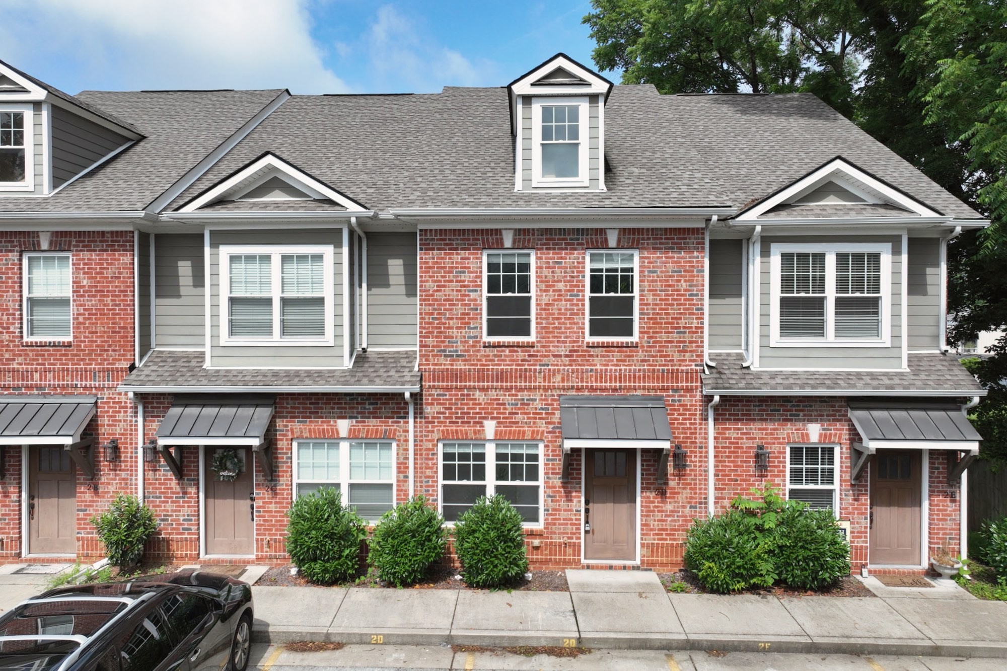 1019 North Maple Street, Unit 2D Murfreesboro, TN 37130 - Photo 4 of 56 a front view of a house with a yard and trees