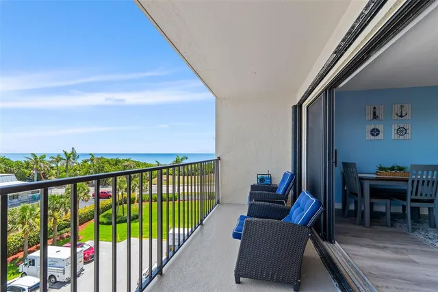 a balcony with furniture and a potted plant