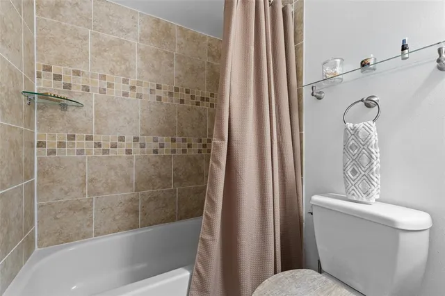 a bathroom with a toilet and shower