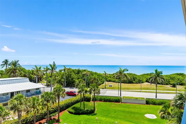 a view of a garden with a building in the background