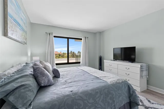 a bedroom with a bed and a television