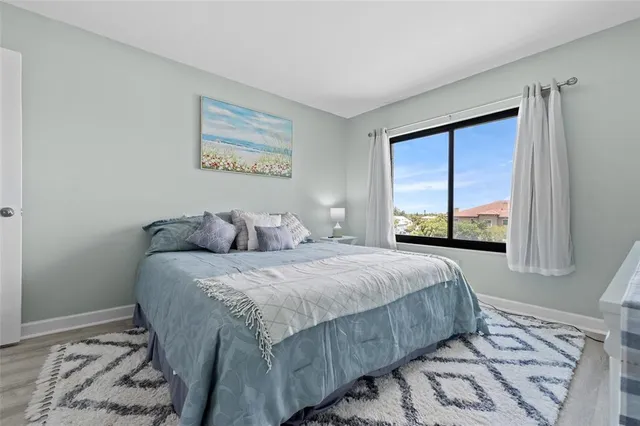 a bed sitting in a bedroom next to a window