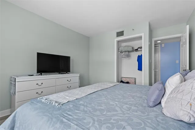 a bedroom with a bed and a flat screen tv