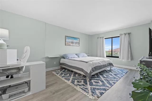 a spacious bedroom with a bed and a window