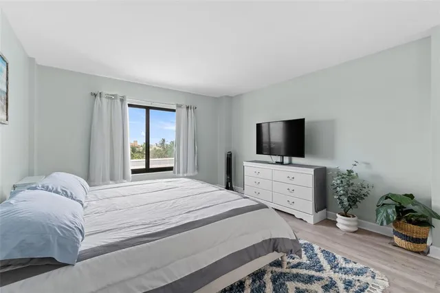a bedroom with a bed and flat screen tv
