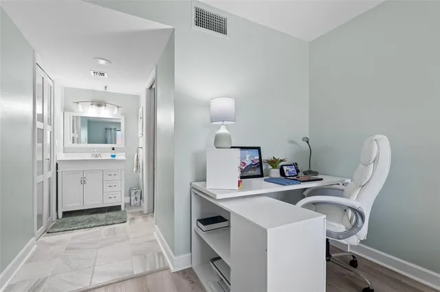 a bathroom with a sink vanity and mirror