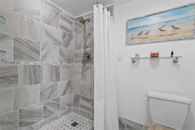 a view of walk in closet with clothes