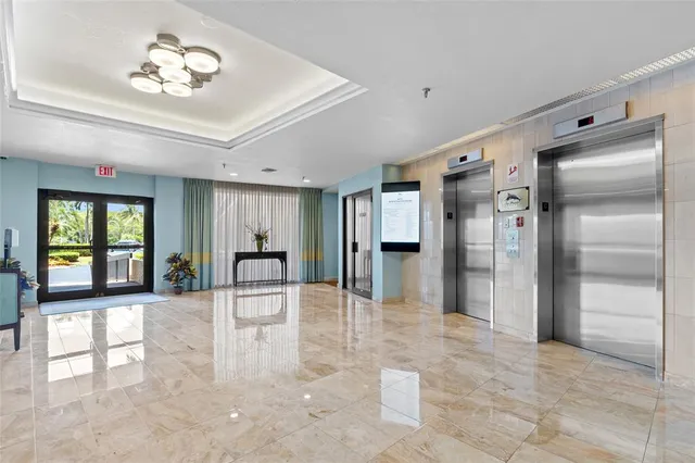 a lobby with furniture and a large window