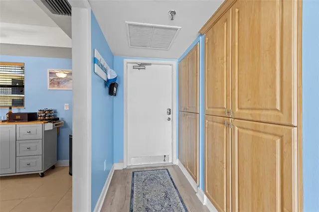 a view of a hallway with closet and cabinet